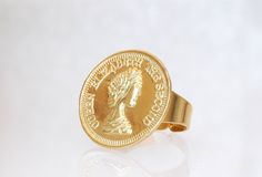 GOLD COIN RING, Coin Ring, Coin Jewelry,Adjustable Ring, Statement Ring, Coin Signet Ring for Women, ring Details of item: Metal: 24k gold plated Diameter of coin is 26 mm Adjustable ring The ring will package in a gift box , TO GET TO MY ETSY SHOP: https://www.etsy.com/il-en/shop/rebekajewelry THANK YOU CHOOSING MY ETSY SHOP REBEKA Gold Coin Shaped Metal Jewelry, Gold Coin Jewelry For Anniversary, Vintage Gold Plated Hoop Earrings As Gift, Vintage Gold-plated Hoop Earrings As A Gift, Vintage Gold-plated Hoop Earrings For Gift, Gold Coin Jewelry For Wedding, Nickel-free Gold Rings For Formal Occasions, Elegant Gold Coin-shaped Earrings, Vintage Gold Plated Hoop Jewelry