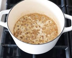 a pot filled with liquid sitting on top of an oven