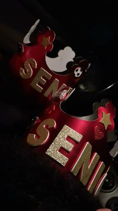 two red and gold crowns with mickey mouse ears on them, one is for someone's 3rd birthday