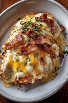 a close up of a plate of food with cheese and bacon on it's side