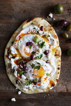 an egg and cheese pita bread with olives