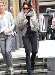 two women are walking down the street together