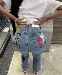 a woman standing in front of an escalator with her back to the camera