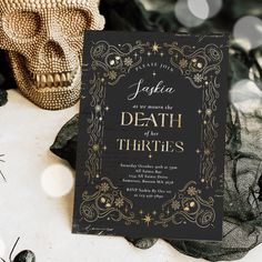 a black and gold halloween party card with a skull in the background on a table