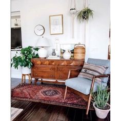 a living room filled with furniture and plants