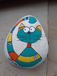 a painted rock with a cat on it