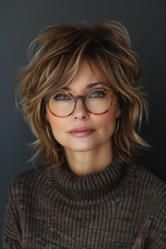 Choose from hairstyles that offer a tousled, voluminous look with subtle layers and dynamic highlights, perfect for any woman over 50 looking to pair her hairstyle with stylish glasses. Artist Hairstyles Women, Shag Haircut With Glasses, Tousled Hairstyles, Fine Hair Bangs, Subtle Layers, Women Haircuts, Messy Bob Hairstyles, Sophisticated Hairstyles, Shaggy Short Hair