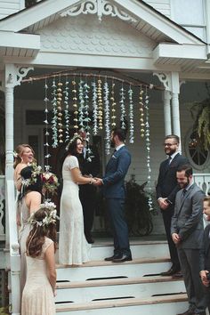 a couple getting married on the steps of their house