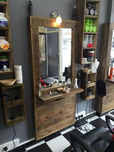 a barber shop with chairs, mirrors and shelves