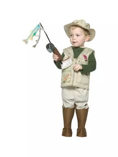 a little boy in a cowboy outfit holding a fishing rod and a fish on it's tip