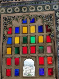 an ornate window with multicolored glass in the middle