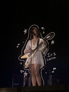 a woman standing on top of a stage holding a guitar