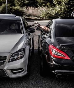 two cars parked next to each other in a parking lot