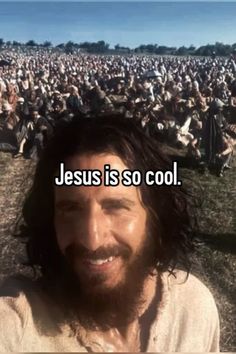 a man with long hair and beard standing in front of a large crowd that says jesus is so cool