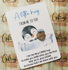 a card with an image of a penguin and a heart on it that says, a little hug from me to you