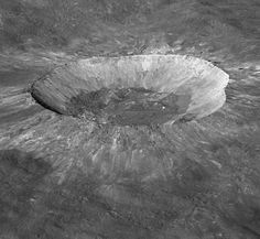 an aerial view of a crater in the ground with water on it's surface