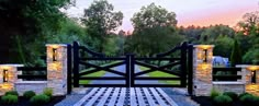 a stone and wood gate with lights on it