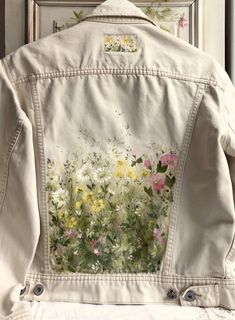 a white jacket with flowers painted on it