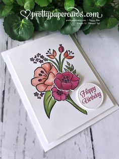 a card with flowers on it and the words happy birthday written in front of it