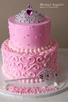 a pink cake with a tiara on top