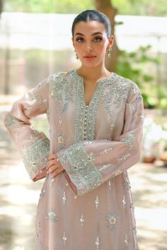 "A contemporary take on a classic kaftan silhouette, cut from tissue, in an elegant shade of blush pink. Dispersed kamdani and zardoze details with a cutworked hem elevate the look." Elegant Pink Kurta With Dabka Work, Pink Wedding Kaftan For Eid, Pink Kaftan With Dabka Work For Wedding, Pink Wedding Kaftan With Dabka Work, Pink Kurta With Pearl Embroidery For Eid, Elegant Pink Organza Kurta, Elegant Pink Kurta For Eid, Elegant Pink Kurta With Resham Embroidery, Pink Resham Embroidery Kaftan For Wedding