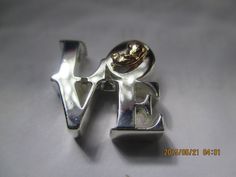 "This sterling silver love necklace is a replica of the famous Pop-Art love sculpture originally created as a Christmas card by Robert Indiana in 1964. When asked if he meant romantic love or brotherly love, he said he meant \"God's love for man\"! The pre-born baby is cast in 14Kt Rose or yellow gold and tucked into the O of LOVE. Beautiful, elegant and sporty this is 17mm square (approx. 3/4\") and a full 5mm thick. It is a high polished It comes with a very sturdy 18\" sterling silver box cha Silver Jewelry For Valentine's Day, 14k Gold Jewelry For Anniversary, Mother's Day Gift, Famous Pop Art, Congratulations Pregnancy, Adjustable Heart-shaped Name Necklace For Mother's Day, Heart Necklace For Anniversary, Mother's Day With Hallmark, Pregnancy Necklace, Love Sculpture, Diamond Necklace Wedding