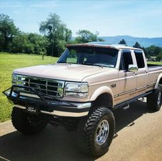 a white pickup truck parked on the side of a road