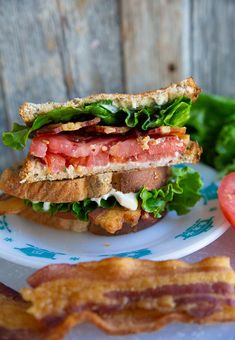 a sandwich with bacon, lettuce and tomato on a plate