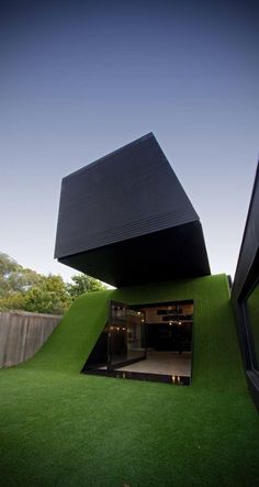 an unusual house with grass on the outside