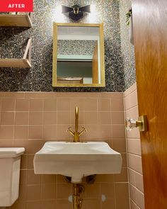 a bathroom with a sink, mirror and shelf above it's door that is open