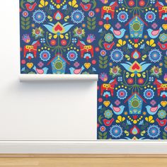 an image of colorful wallpaper with flowers and birds on the blue background that is in front of a white door