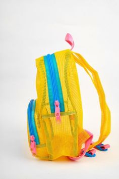 A great sporty style as a daily bag, beach buddy, or festival companion. This small backpack features a large front pocket with double zipper pull and main compartment. Super soft adjustable top loop & webbing. Content + Care Tear resistant 100% vinyl coated mesh Spot Clean Made in USA Size 13" height x 10" width x 4.5" main pocket depth, 1 lb 6" deep including front pocket | Mokuyobi Mesh Mini Backpack in Yolk, Men's at Urban Outfitters Daily Use Mesh Backpack Bag, Yellow Mini Backpack, On-the-go Bucket Backpack With Removable Pouch, Nylon Backpack With Removable Pouch For On-the-go, Mesh Backpack, Daily Bag, Small Backpack, Mini Backpack, Sporty Style