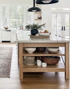 a kitchen island with bowls and baskets on it