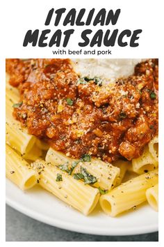 pasta with meat sauce and parmesan cheese on top is served in a white bowl