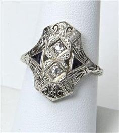 - Vintage 14k White Gold Art Deco Diamond Ring- Gorgeous details on face and shoulders- Ring size 8.25- Diamonds each measure 2mm in diameter- Ring face measures .8" tall by .72" wide and .24" deep- Wonderful vintage condition, signed / marked "BE"  "ML"- Weighs 4.2 gramsA wonderful antique ring! 14k Gold Art Deco Jewelry, Art Deco Sapphire Ring With Polished Finish, Art Deco Collectible 14k White Gold Rings, Collectible Art Deco 14k White Gold Ring, Collectible Diamond Jewelry With Intricate Design, Diamond Jewelry With Intricate Design For Collectors, Collectible Diamond Filigree Rings, Art Deco Silver Diamond Ring With Polished Finish, Silver Art Deco Diamond Ring With Polished Finish