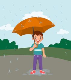 a little boy holding an umbrella in the rain