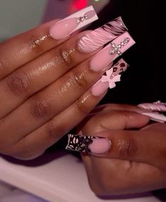 a woman's hands with pink and white nail polishes on their nails,