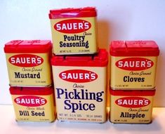 five containers of sauces stacked on top of each other in front of a white wall