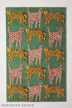 a green rug with pink and yellow cheetah on the front, and an orange cheetah on the back