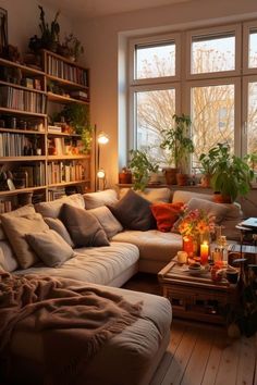 a living room filled with lots of furniture next to a large window covered in plants