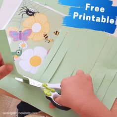 a person cutting paper with scissors on top of it and the words free printable