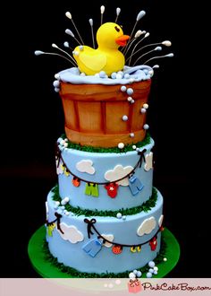 a three tiered cake with a rubber ducky in the tub on it's side