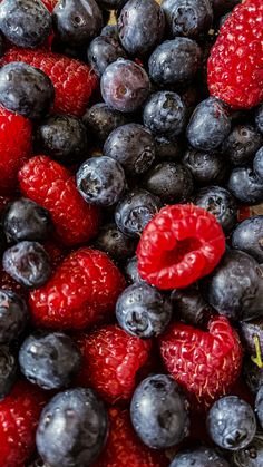 blueberries, raspberries and strawberries are piled together