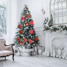 a decorated christmas tree in a living room with white walls and flooring, surrounded by holiday decorations