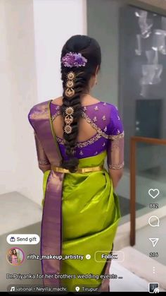 a woman in a green and purple sari with her back turned to the camera