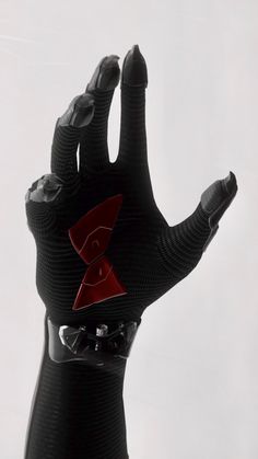 a black glove with red accents on it