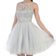 This Is A Silver Dama/Xv Dress That Comes With Both Floral Embroidery And A Rhinestone Sequin. The Sections Carrying Embroidery Are The Upper Chest, Neck, And Upper Back Area. The Upper Chest Area Near The Neck Consists Of A Mesh Design Whilst The Lower Half Of The Dress Has A Tulle. The Dress Is Made Of 100% Polyester And Has Straps. Silver Lace Dress For Prom, Fitted Silver Embroidered Dress, Elegant Embroidered Dress For Homecoming, Elegant Embroidered Homecoming Dress, Fitted Embroidered Silver Dress, Evening Lace Dresses With Rhinestones, Elegant Lace Dress With Rhinestones, Silver Dama Dresses For Quince, Silver Dama Dresses