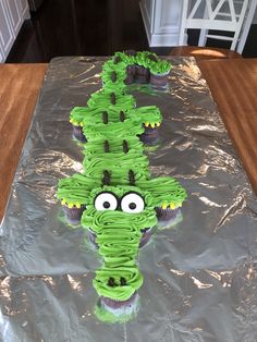 cupcakes in the shape of a cactus sitting on top of a sheet of tin foil