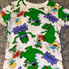 Nwot Rugrats 4/5 Short Sleeved Shirt. Washed And Tried On But Never Worn Out. * Dog-Friendly/ Smoke-Free Home * * Open To Bundles! * Make Me An Offer (: Fun All Over Print Tops For Spring, Playful White Dinosaur Print Top, Fun Spring Tops With All Over Print, Casual Green Dinosaur Print Tops, Casual Green Tops With Dinosaur Print, Funny Print Tops For Spring Playtime, Short Sleeve Dinosaur Print Tops For Playwear, Fun Short Sleeve Tops With Dinosaur Print, Casual Dinosaur Print Tops For Playwear