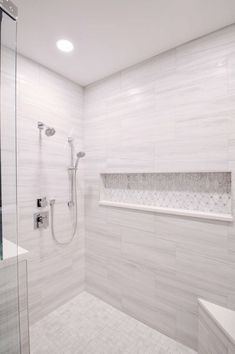 a walk in shower sitting next to a white sink